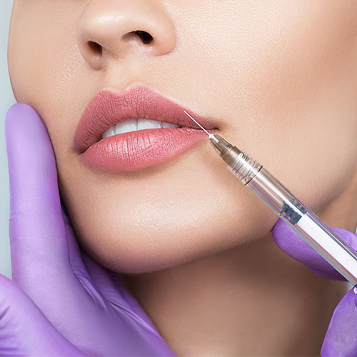 zoomed in womans face having lip filler injection
