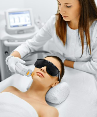Woman wearing sunglasses having rosacea IPL treatment