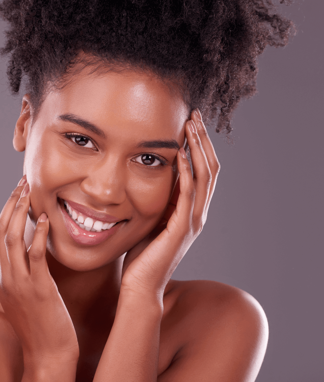Portrait of beautiful black woman touching her cheeks and smiling at camera