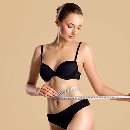 Beautiful Woman Measuring Her Body Size