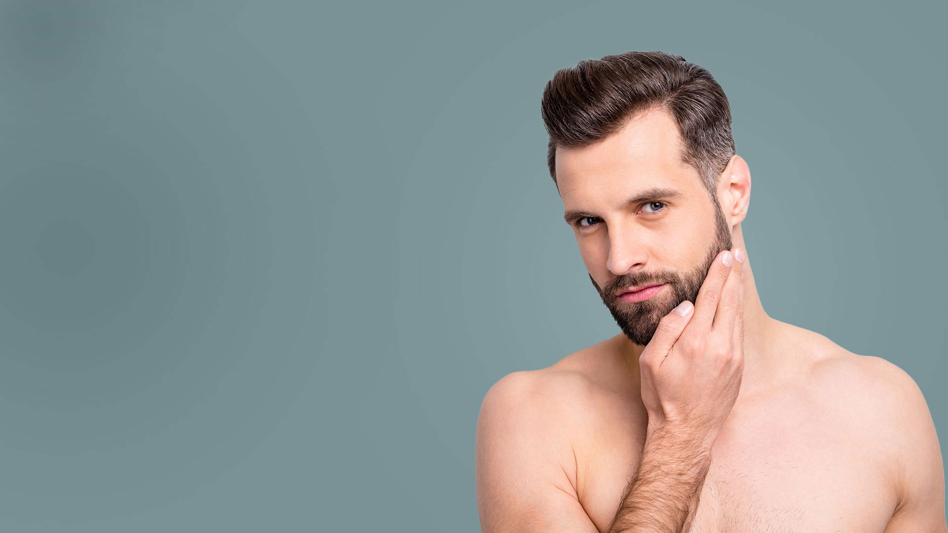 brunette male model touching beard