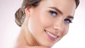 Close-up of young woman with blue eyes smiling warmly