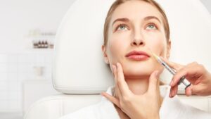 Aesthetic practitioner performing a dermal filler treatment to enhance facial contours and restore volume.